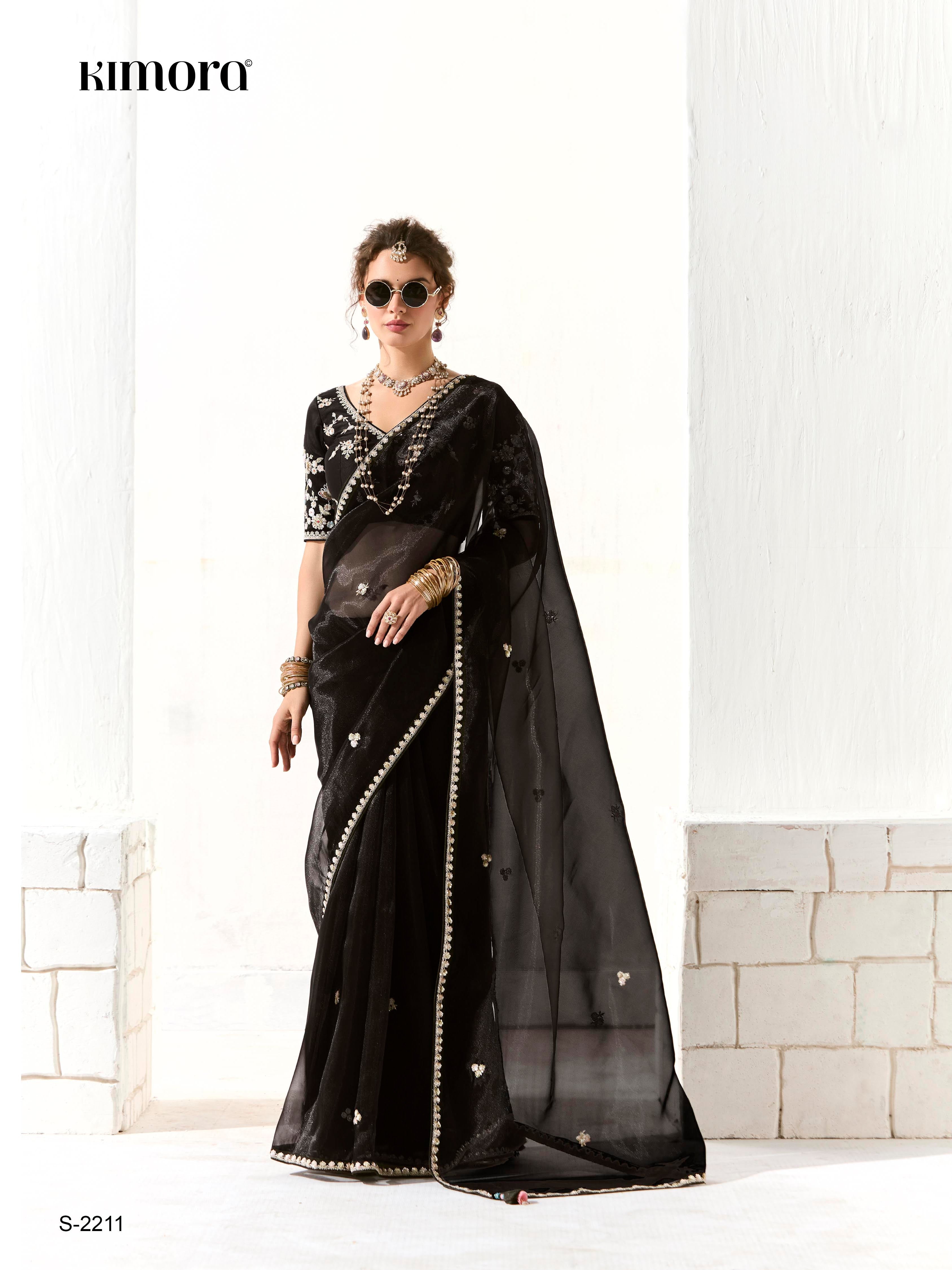 Dhiyona KM Women Royal Black Organza Saree With Black Embroidered Blouse “ A Symphony Of Power And Grace  Meta Description: