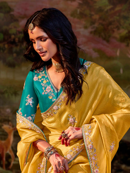 Dhiyona KM Women Yellow Silk Embroidered Butta Saree With Teal Blouse