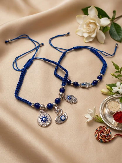 Dhiyona Set Of 2 Blue & Silver Evil Eye Design Bhaiya Bhabhi Rakhi With Roli Chawal Chandan