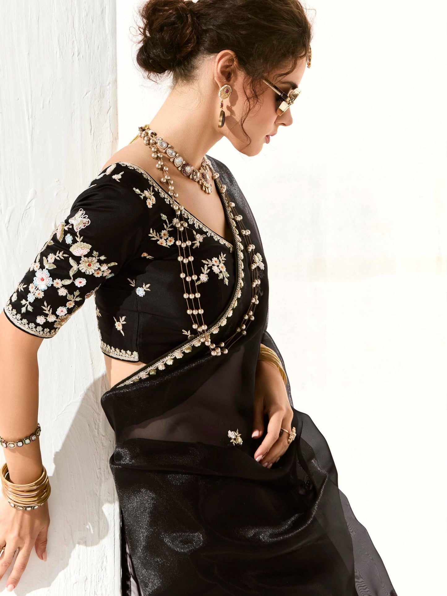 Dhiyona KM Women Royal Black Organza Saree With Black Embroidered Blouse “ A Symphony Of Power And Grace  Meta Description: