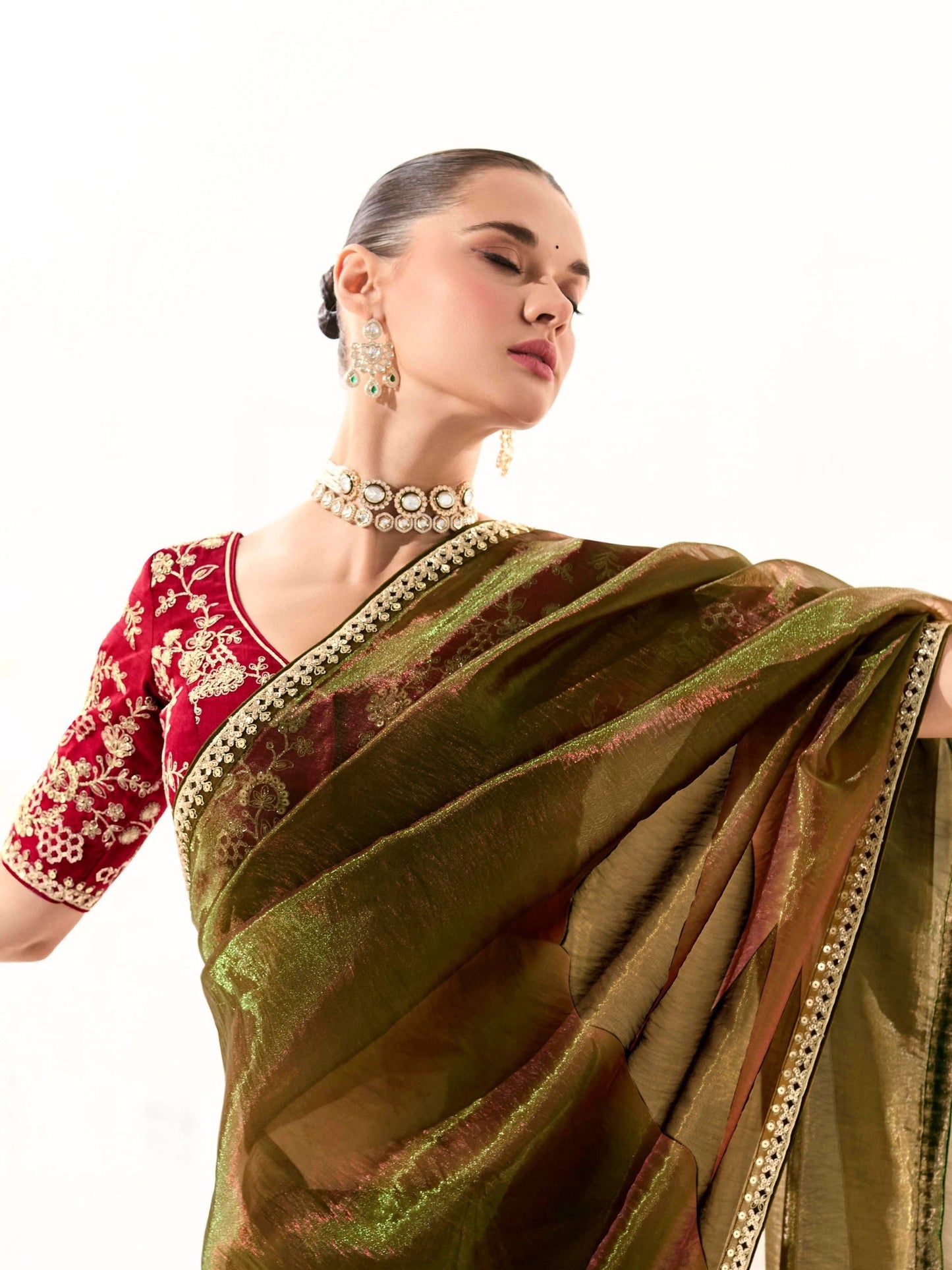 Dhiyona KM Women Mahendi Green Tissue Silk Saree With Red Blouse “ Inspired By Tradition & Bold Elegancemahendi Green Tissue Silk Saree With Red Blouse
