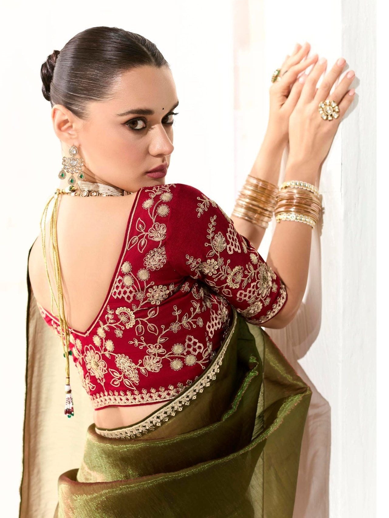 Dhiyona KM Women Mahendi Green Tissue Silk Saree With Red Blouse “ Inspired By Tradition & Bold Elegancemahendi Green Tissue Silk Saree With Red Blouse