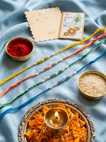 Dhiyona Set Of 4 Multicolor Artificial Beads Thread Rakhi With Roli Chawal Chandan Mishri