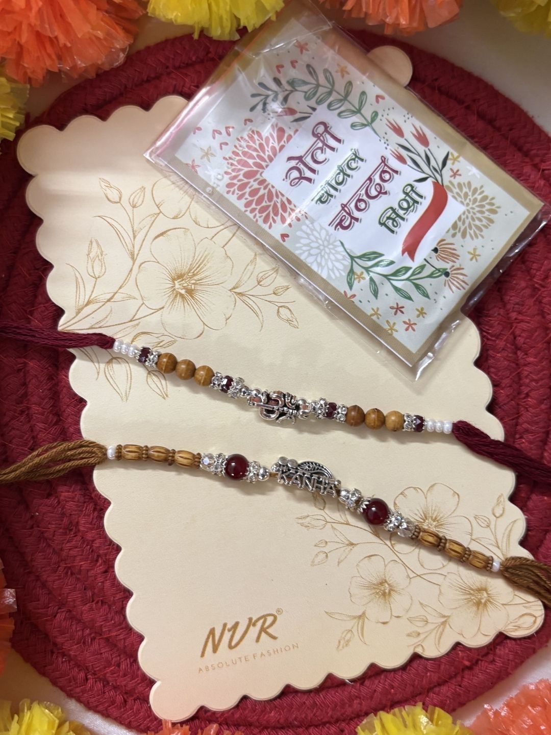 Dhiyona Set Of 2 Silver Toned Religious Rakhi Thread Rakhi Roli Chawal Chandan Mishri