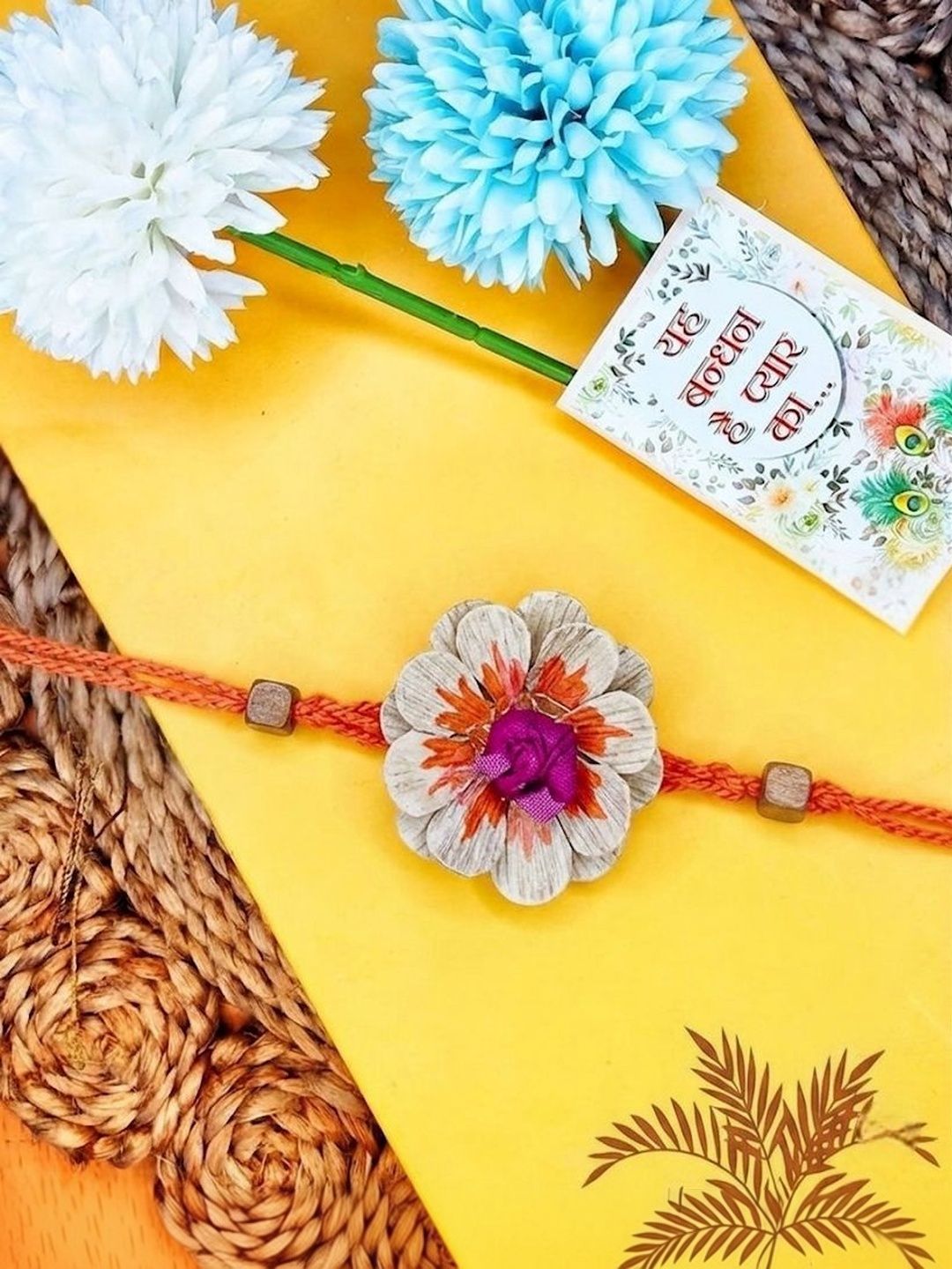 Dhiyona Multicolor Floral Design Plant Seed Rakhi With Roli Chawal Chandan Mishri