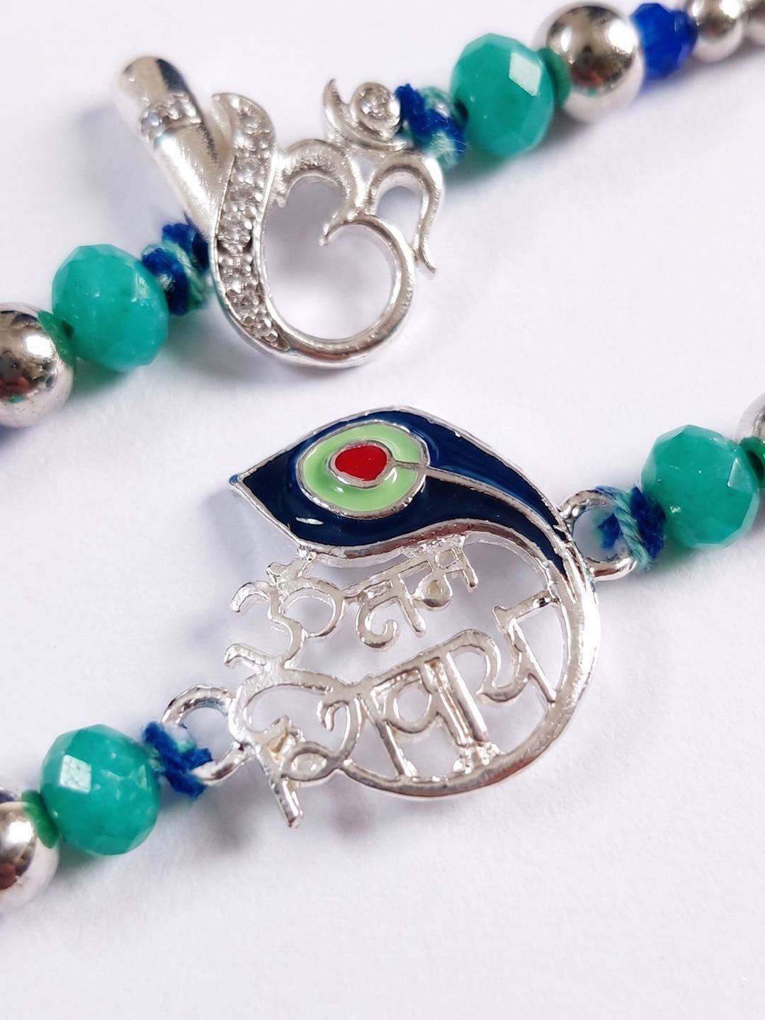 Dhiyona Set Of 2 Silver Toned Beaded Religious Thread Rakhi With Roli Chawal Chandan Mishri