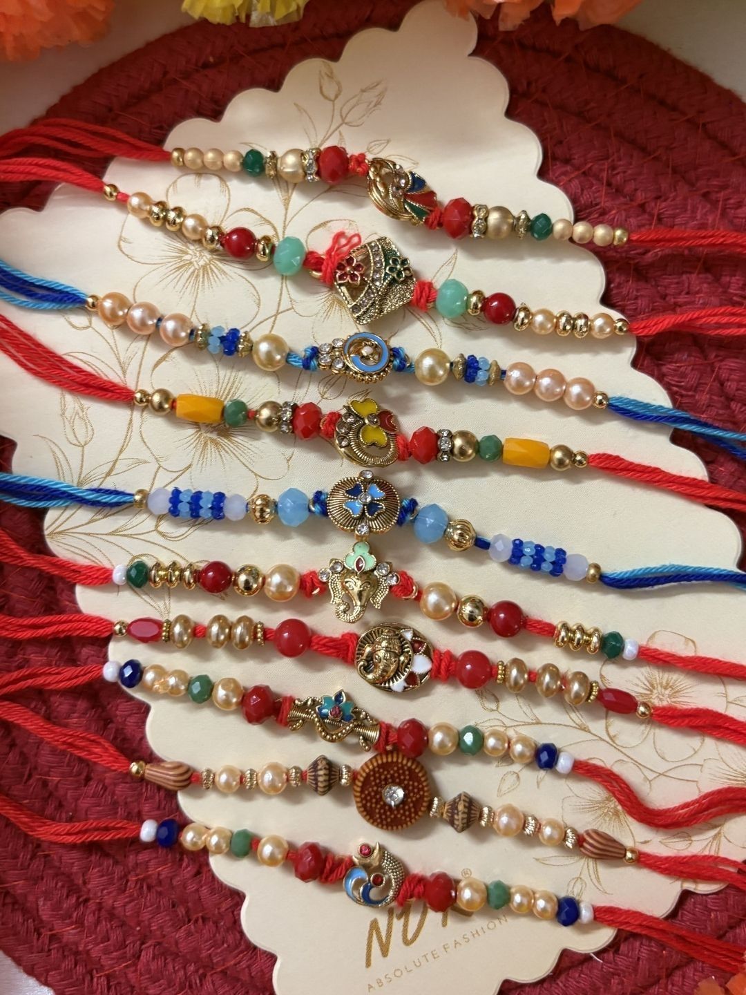 Dhiyona Set Of 10 Artificial Stones & Beads Thread Rakhi With Roli Chawal Chandan Mishri