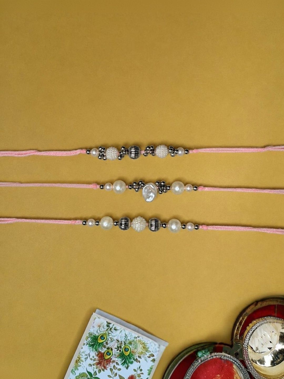 Dhiyona Set Of 3 White Pearls Thread Rakhi With Roli Chawal Chandan Mishri