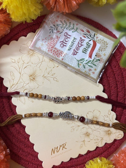 Dhiyona Set Of 2 Silver Toned Religious Rakhi Thread Rakhi Roli Chawal Chandan Mishri