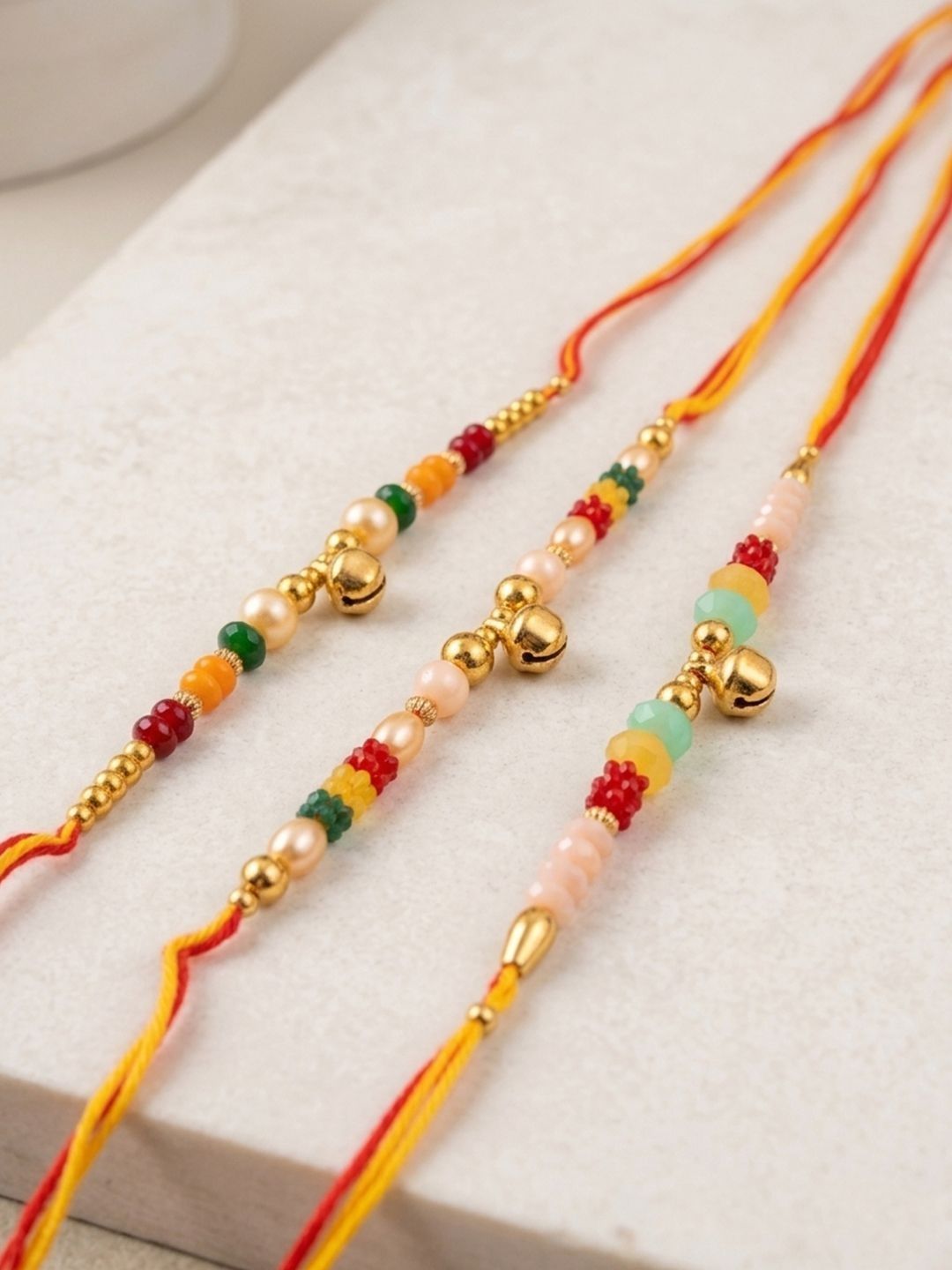 Dhiyona Set Of 3 Artificial Beads Orange Thread Rakhi With Roli Chawal Chandan Mishri