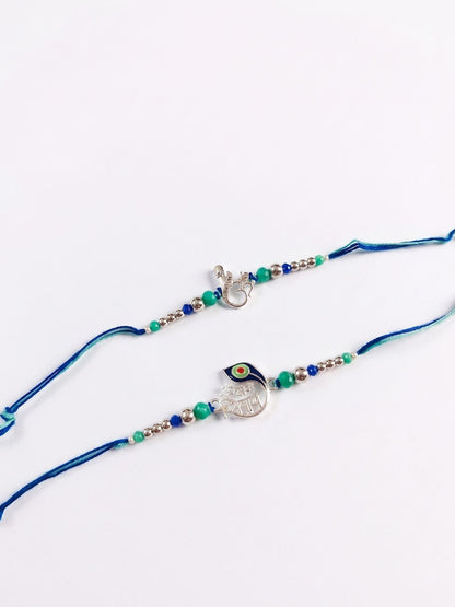 Dhiyona Set Of 2 Silver Toned Beaded Religious Thread Rakhi With Roli Chawal Chandan Mishri