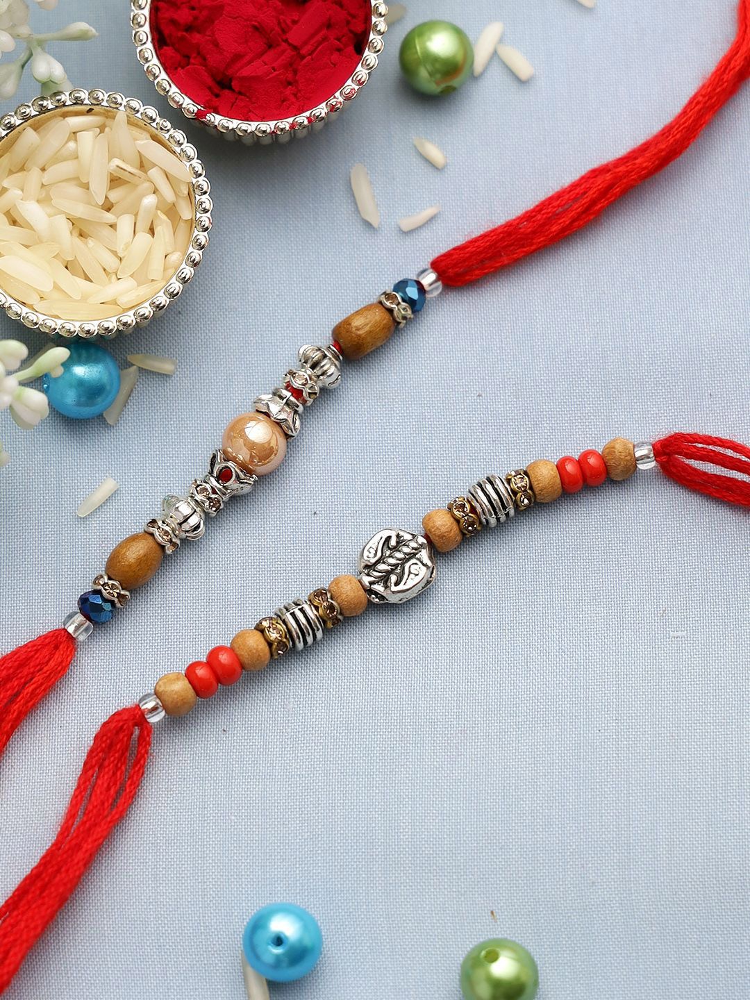 Dhiyona Set Of 2 Silver-Toned Beaded Rakhi With Roli Rice & Greeting Card