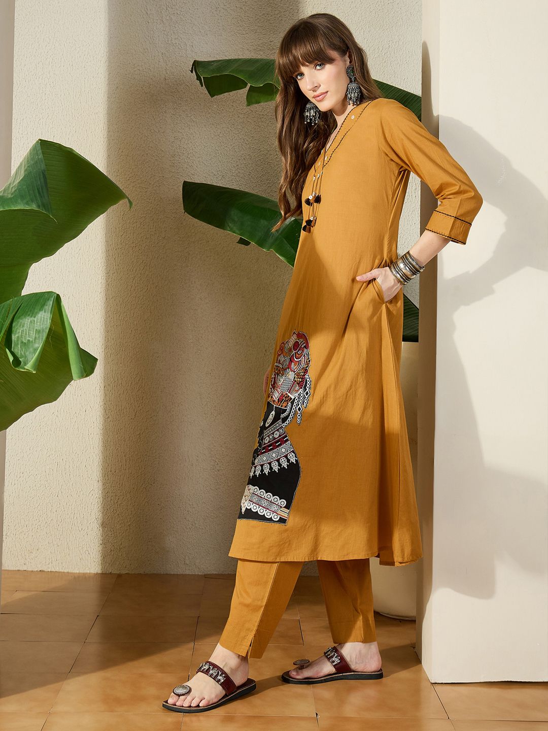 Women Mustard Embroidered A-Line Kurta Trousers Set