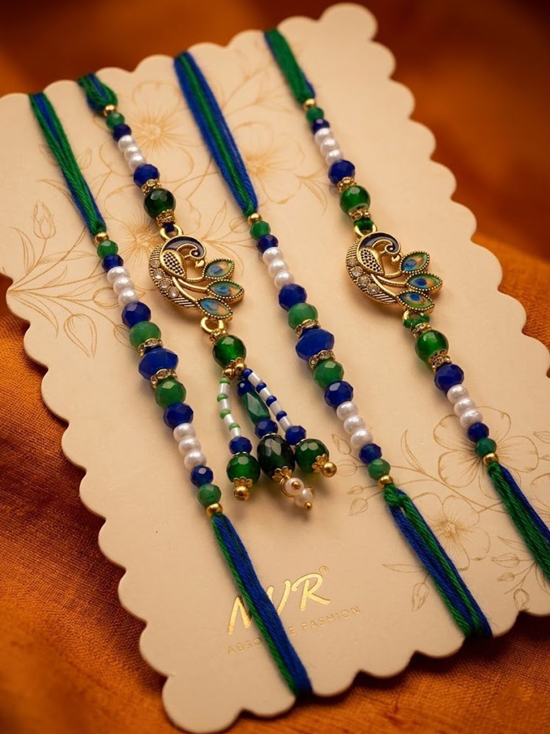 Dhiyona Set Of 4 Green Peacock Design Artificial Beads Thread Rakhi With Roli Chawal