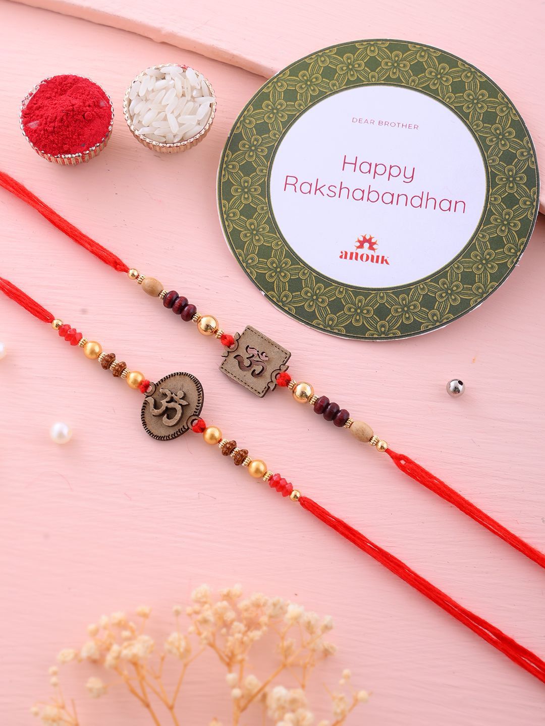 Dhiyona Set Of 2 Red Wooden Om Beaded Rakhi With Roli Rice & Greeting Card