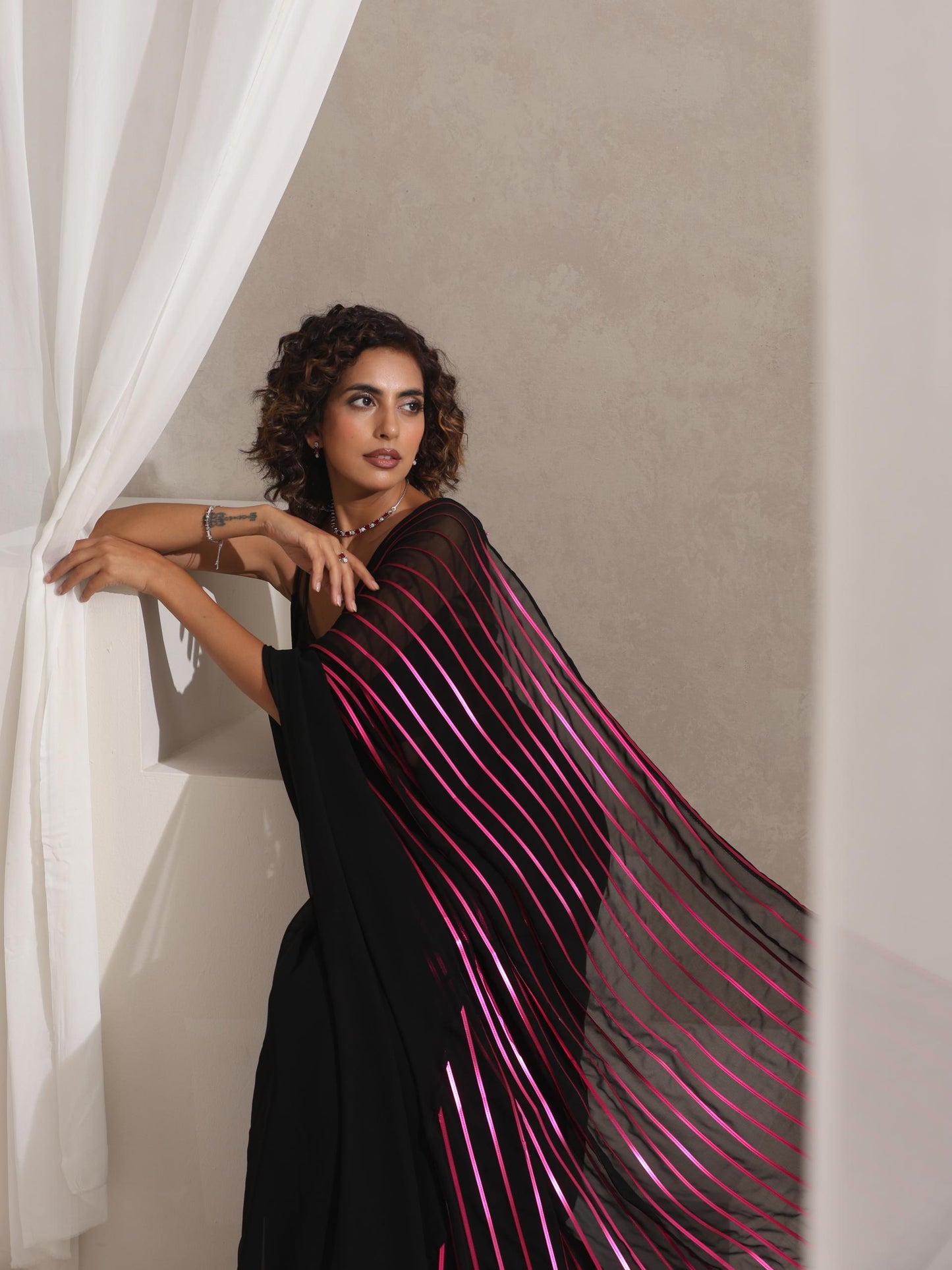 Dhiyona ST Black and Pink Impression Georgette Saree