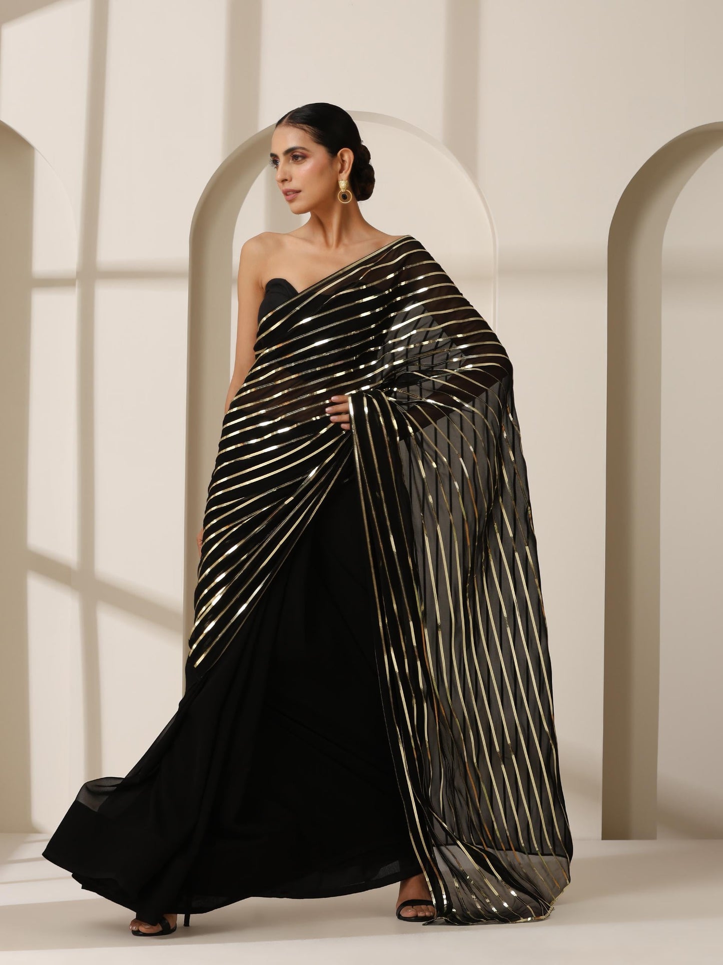 Dhiyona ST Black And Gold Impression Georgette Saree