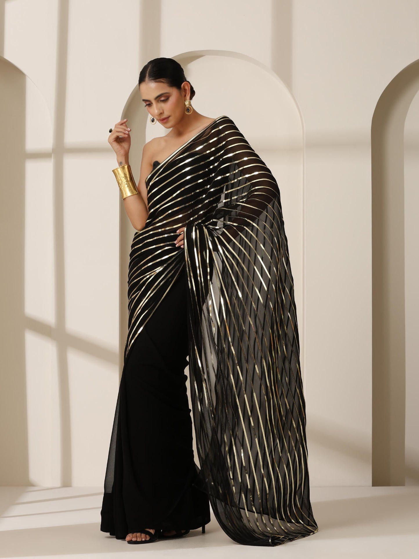 Dhiyona ST Black And Gold Impression Georgette Saree