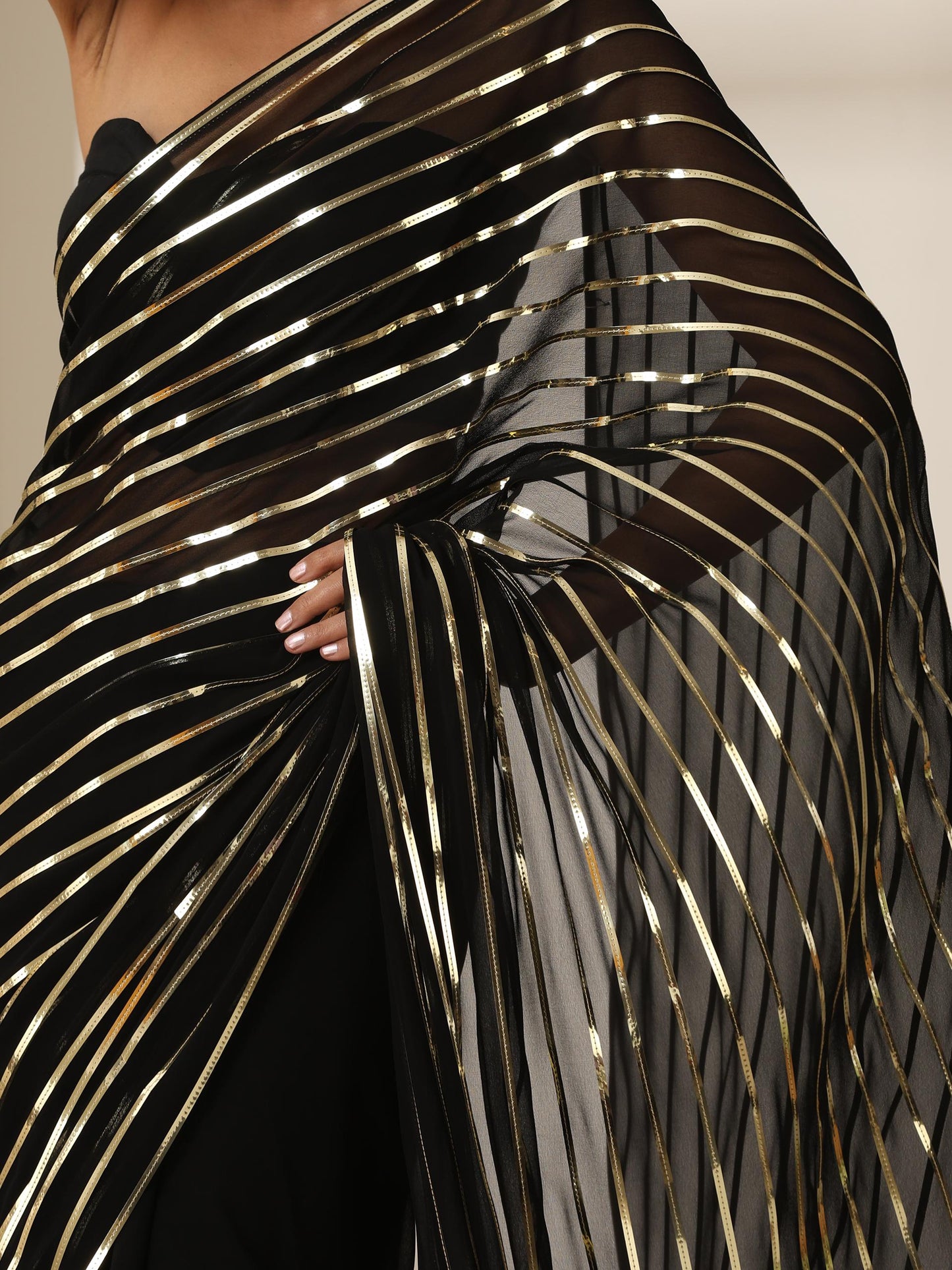 Dhiyona ST Black And Gold Impression Georgette Saree