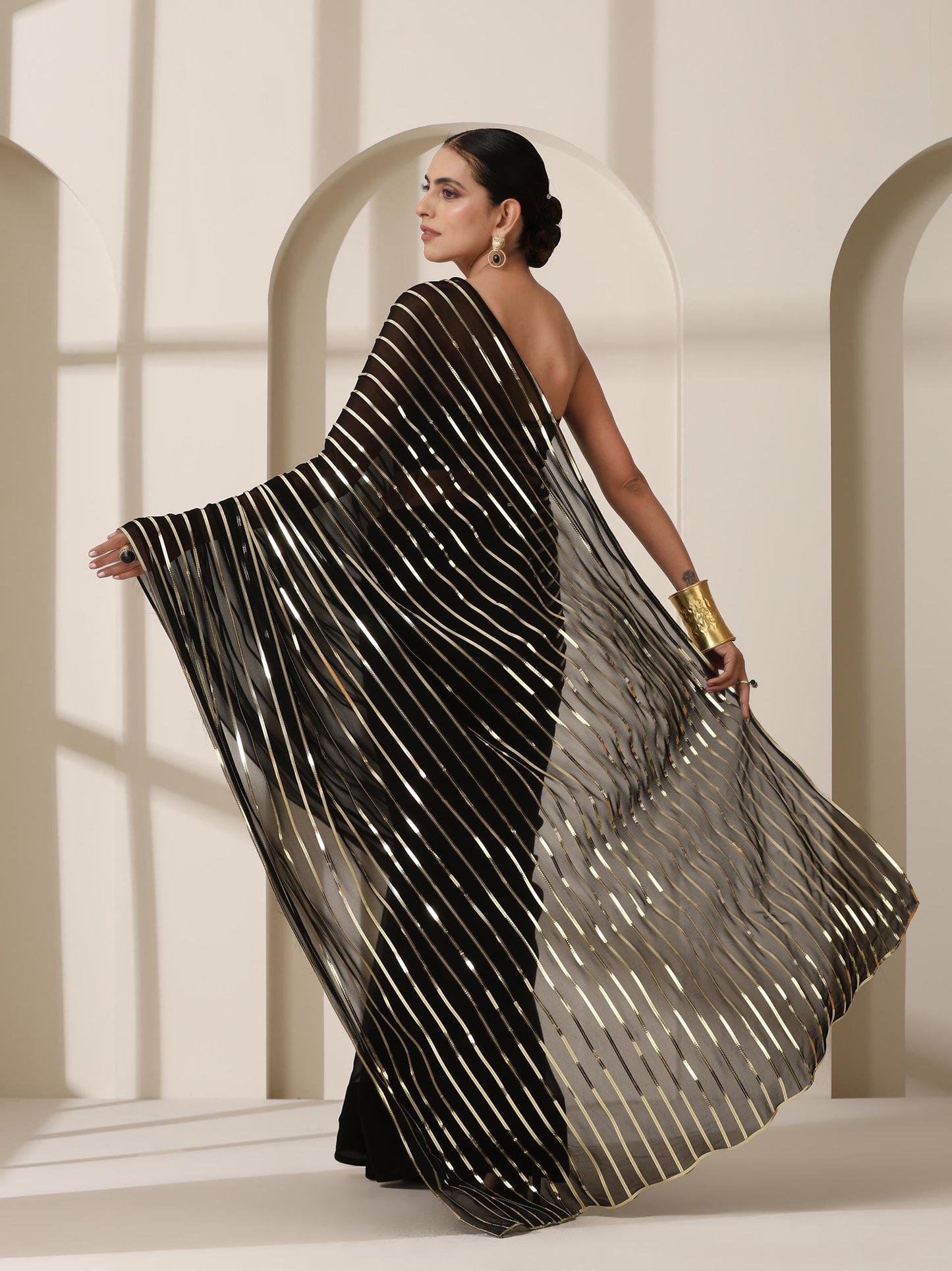 Dhiyona ST Black And Gold Impression Georgette Saree