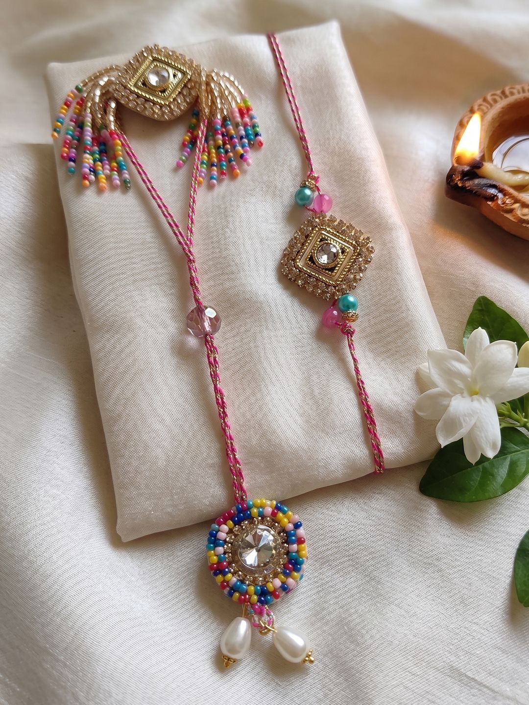 Dhiyona Set Of 2 White Artificial Stones Golden Toned Bhaiya Bhabhi Rakhi With Roli Chawal