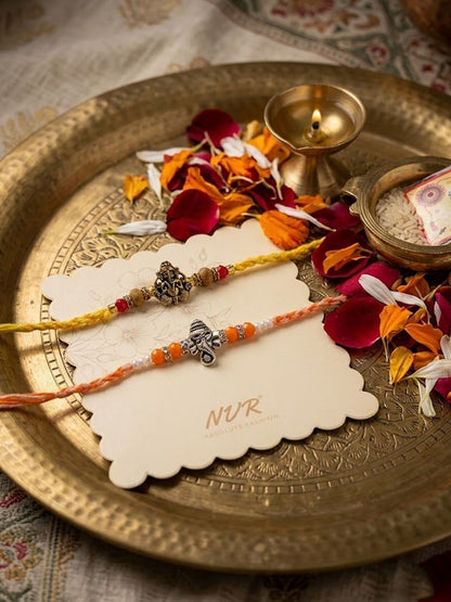Dhiyona Set Of 2 Multicolor Religious Thread Rakhi With Roli Chawal Chandan Mishri