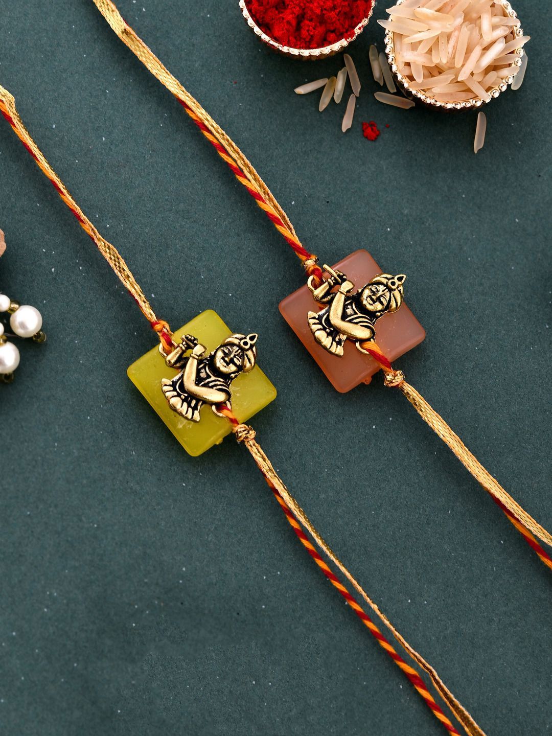 Dhiyona Set Of 2 Red Kanhaiya Rakhis With Roli Chawal & Greeting Card