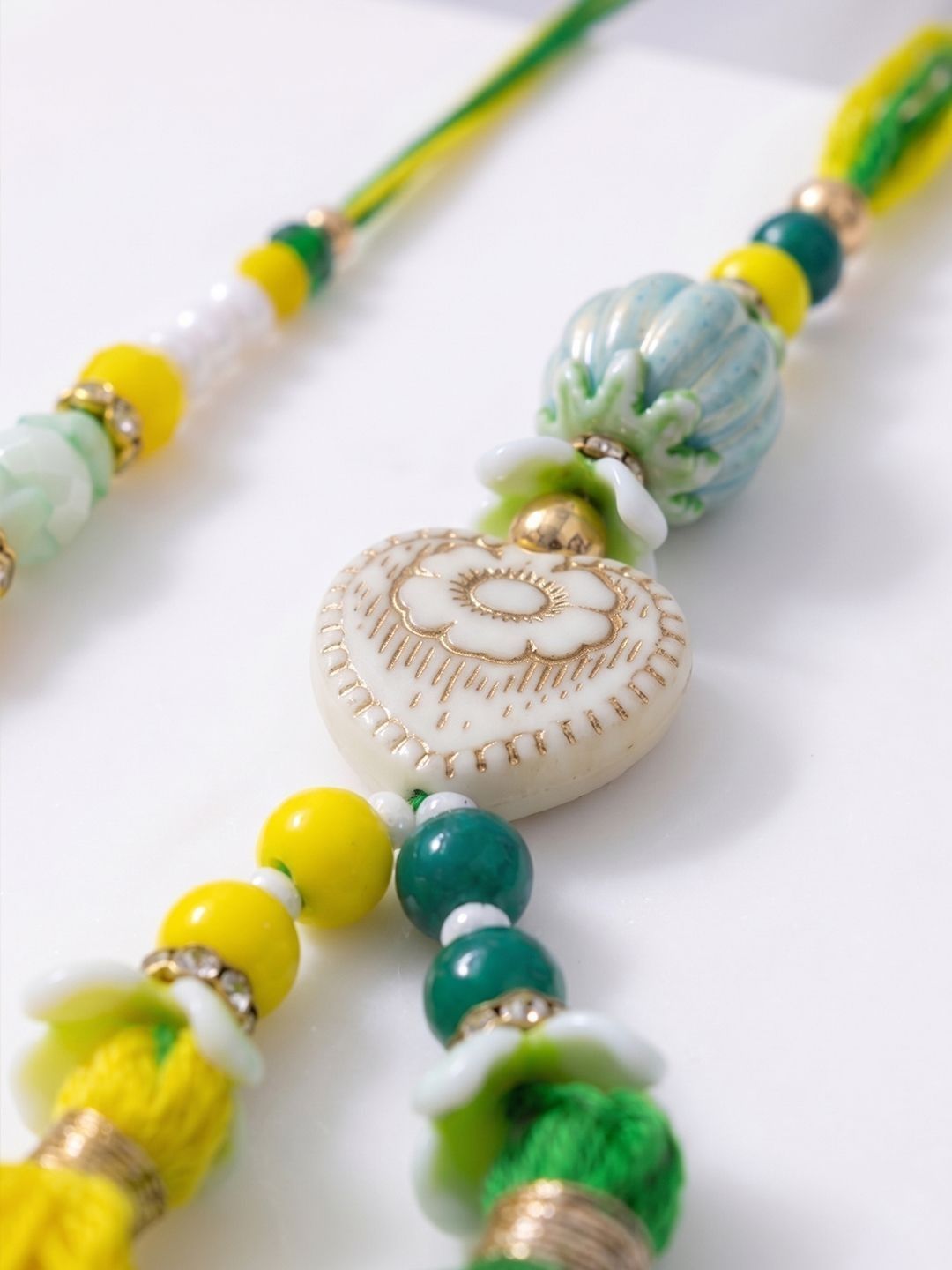 Dhiyona Set Of 2 Green & Yellow Beaded Heart Shape Bhaiya Bhabhi Rakhi With Roli Chawal