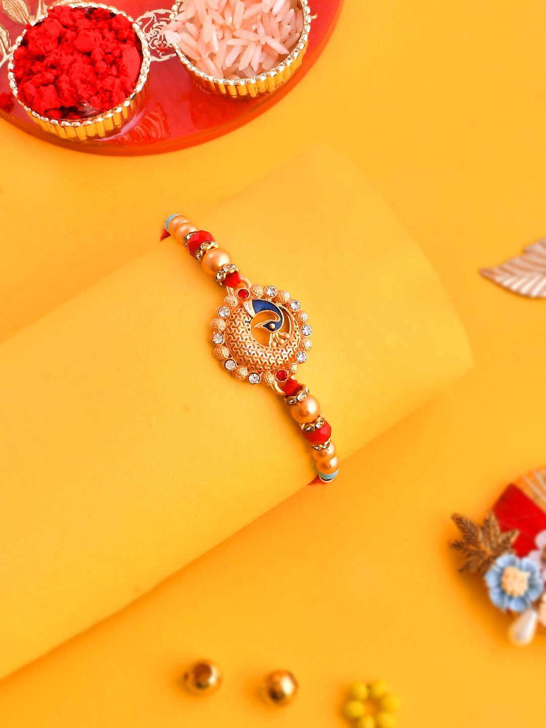 Dhiyona Gold Toned Beaded Peacock Patterned Rakhi With Roli Chawal & Greeting Card