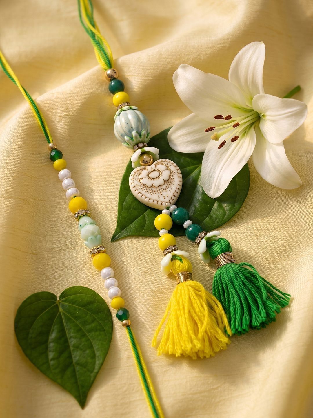 Dhiyona Set Of 2 Green & Yellow Beaded Heart Shape Bhaiya Bhabhi Rakhi With Roli Chawal