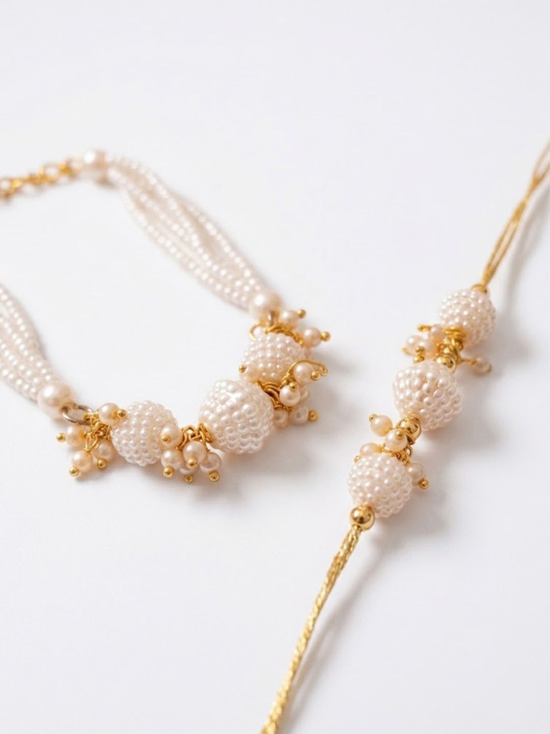Dhiyona Set Of 2 Gold Toned & White Pearls Bhaiya Bhabhi Rakhi