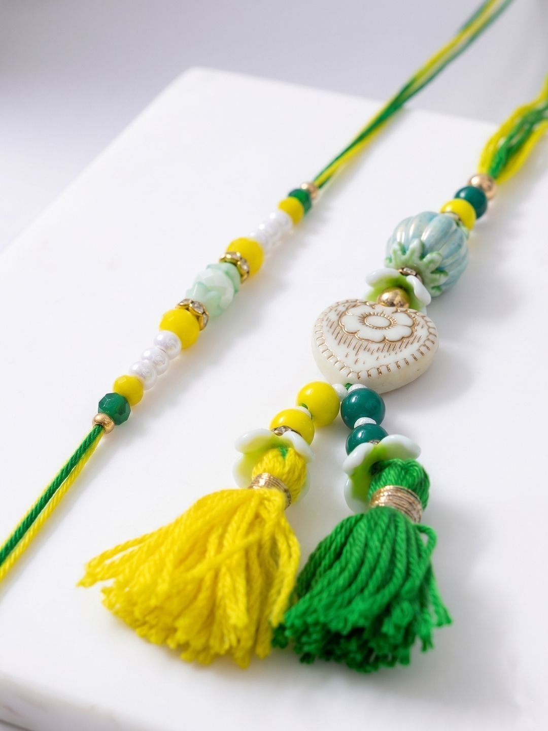 Dhiyona Set Of 2 Green & Yellow Beaded Heart Shape Bhaiya Bhabhi Rakhi With Roli Chawal