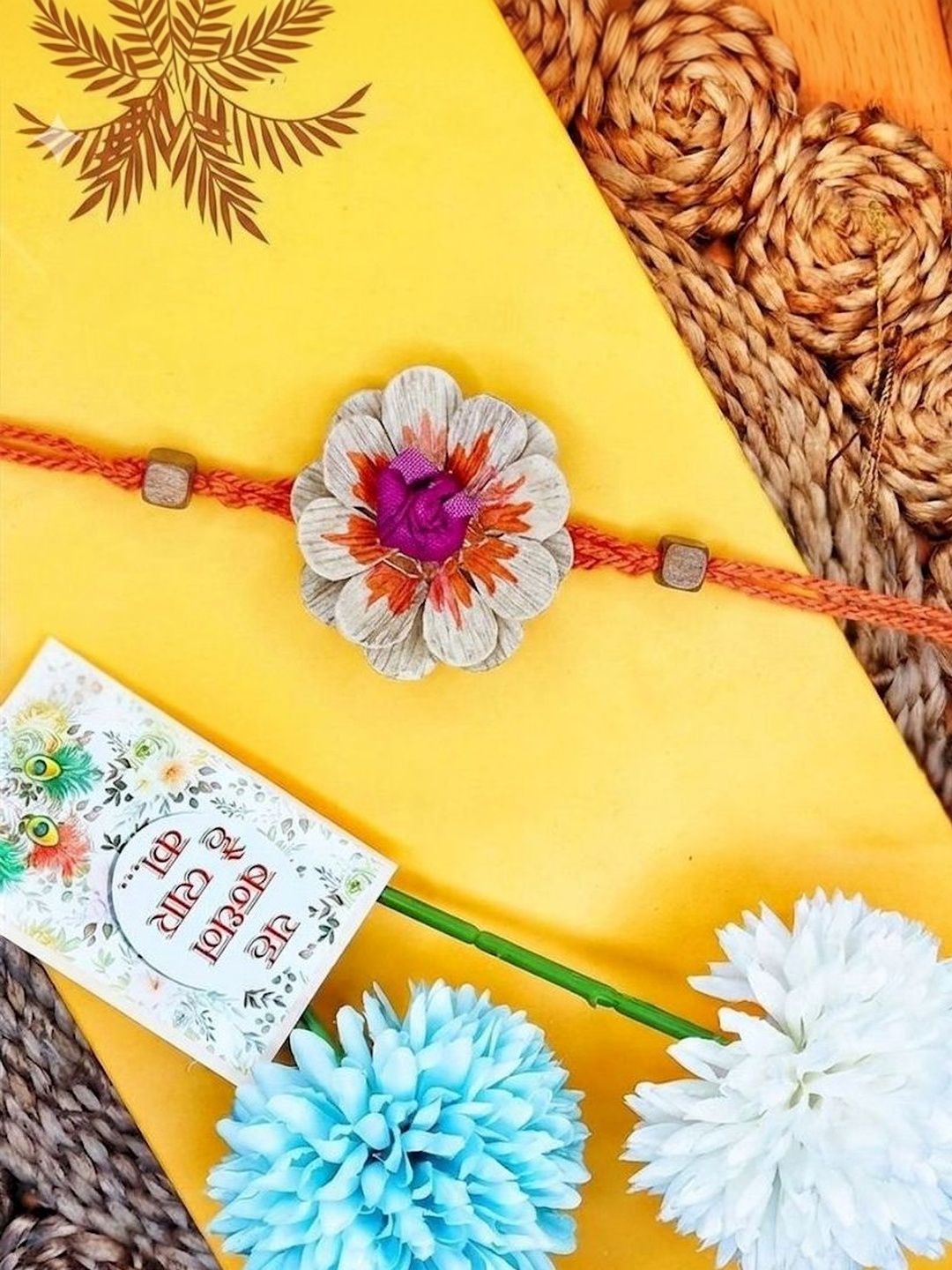 Dhiyona Multicolor Floral Design Plant Seed Rakhi With Roli Chawal Chandan Mishri