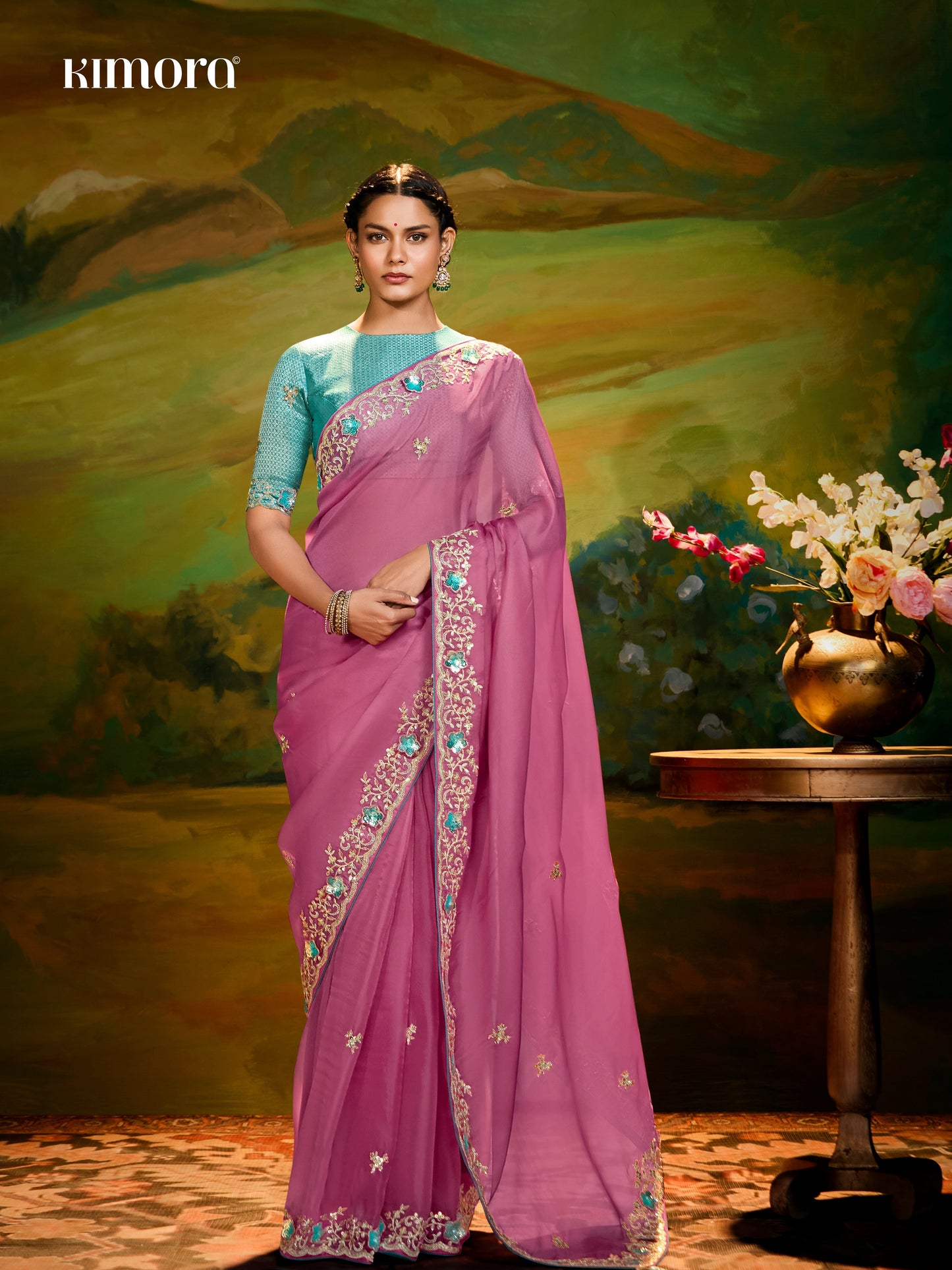 Dhiyona KM Women The Pink Silk Saree With Teal Blouse