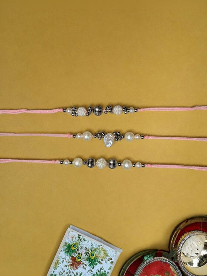 Dhiyona Set Of 3 White Pearls Thread Rakhi With Roli Chawal Chandan Mishri