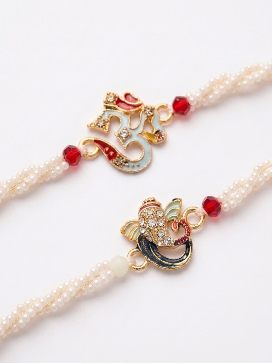 Anouk Set Of 2 White Pearls Om & Ganesh Ji Thread Rakhi With Roli Chawal Chandan Mishri