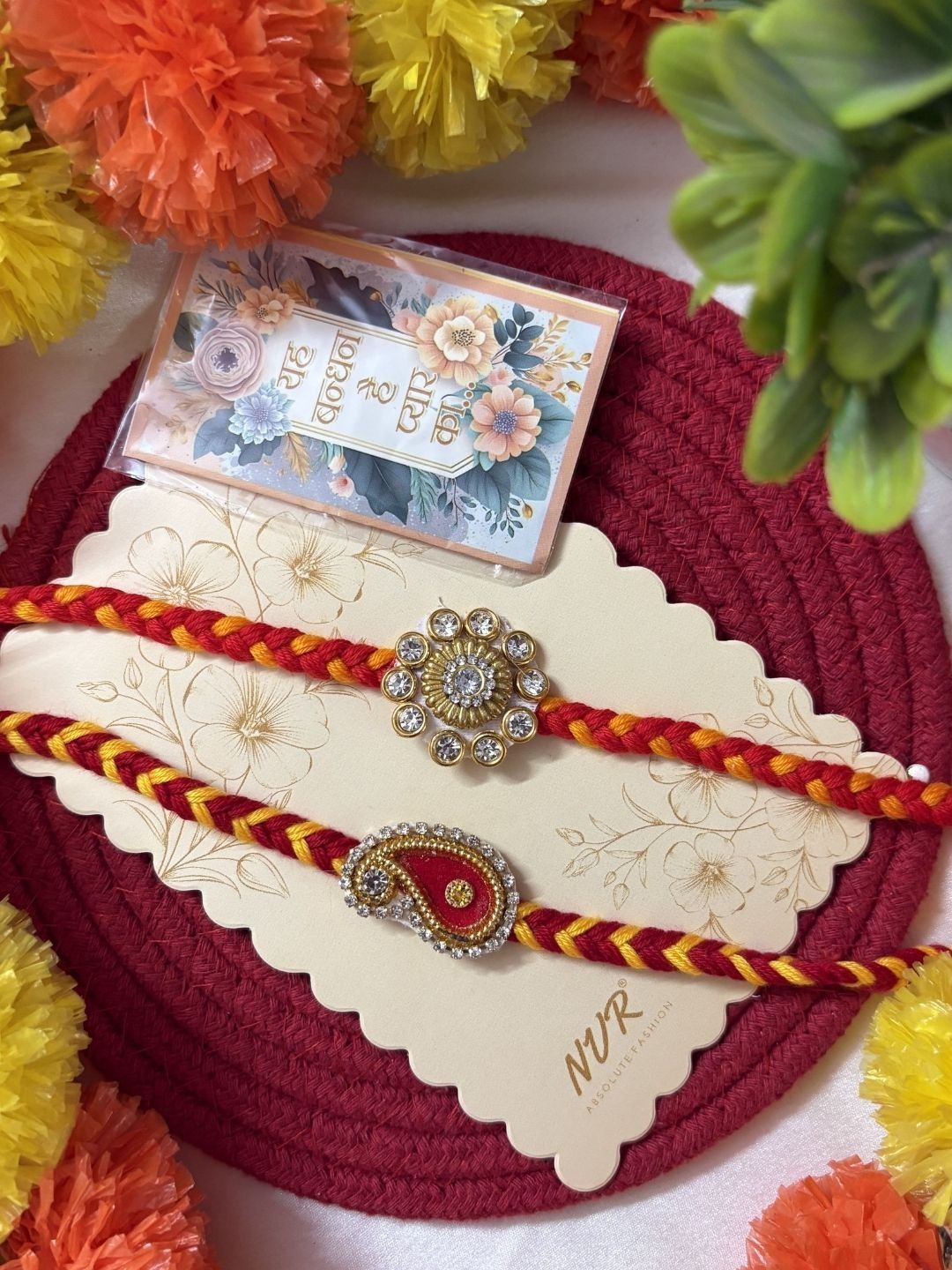 Dhiyona Set Of 2 Gold & Red Thread & Kundan Rakhi With Roli Chawal Chandan Mishri