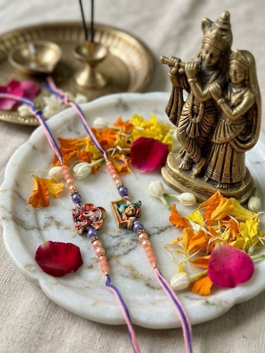 Dhiyona Set Of 2 Krishna Ji & Ganesh Ji Beaded Religious Thread Rakhi With Roli Chawal