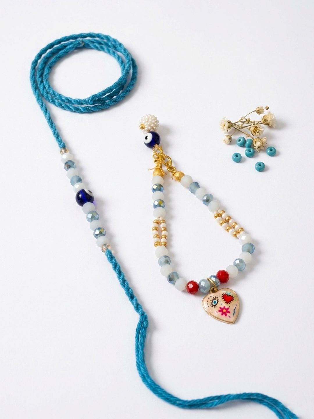 Dhiyona Set Of 2 Evil Eye Beaded Gold Toned Bhaiya Bhabhi Rakhi With Roli Chawal Chandan