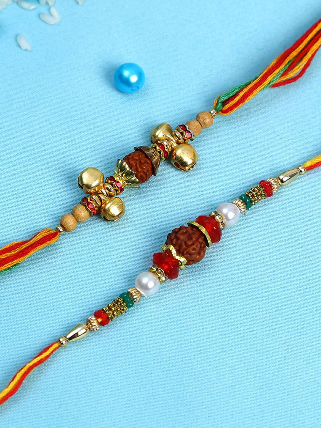 Dhiyona Set Of 2 Small Bells & Rudaraksh Rakhi Comes With Roli Rice & Greeting Card