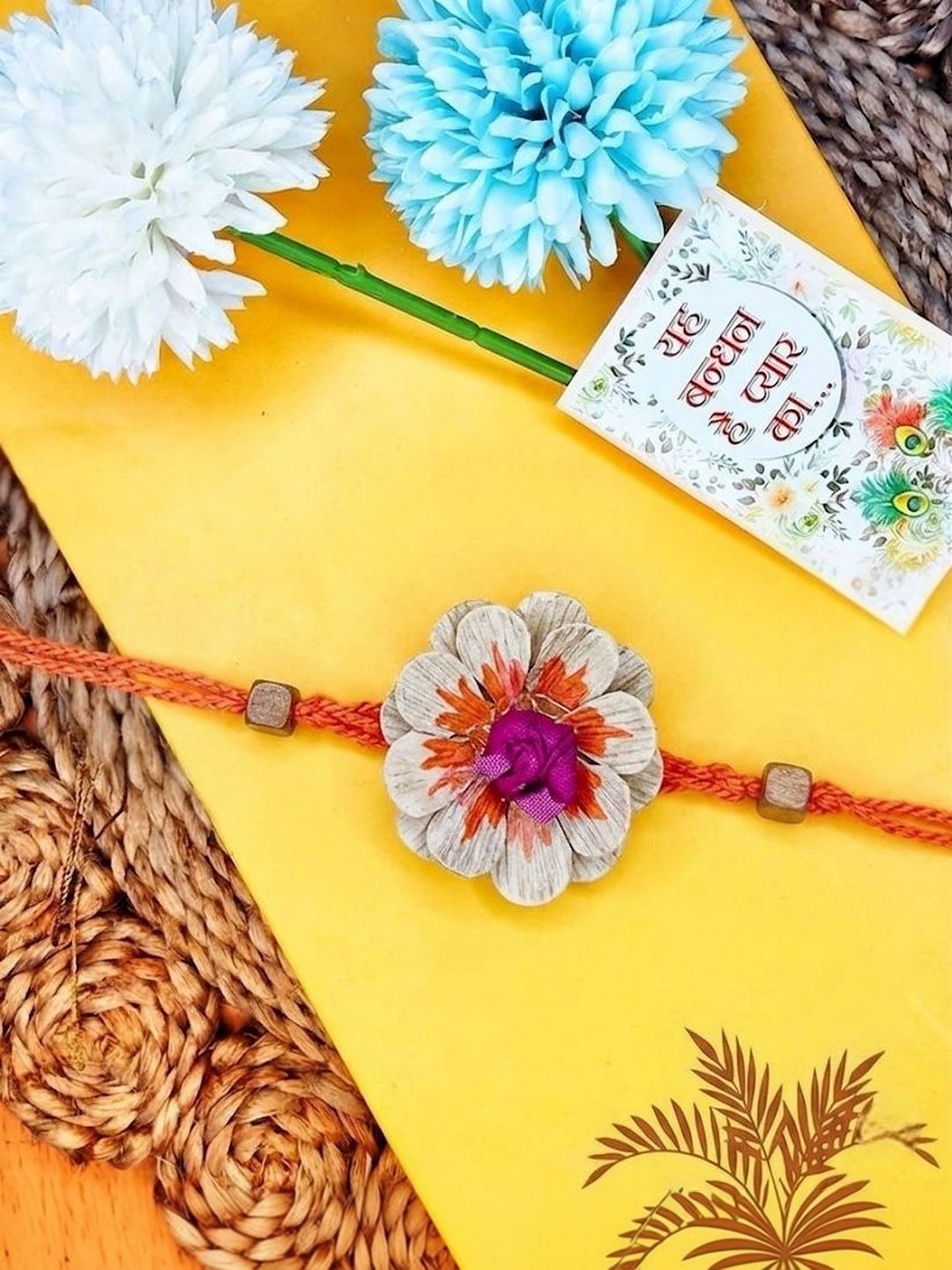 Dhiyona Multicolor Floral Design Plant Seed Rakhi With Roli Chawal Chandan Mishri