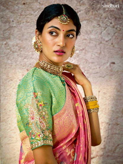 Dhiyona KM Women Pastel Pink Banarasi Silk Saree With Zari Weaving & Contrast Green Embroidered Blouse
