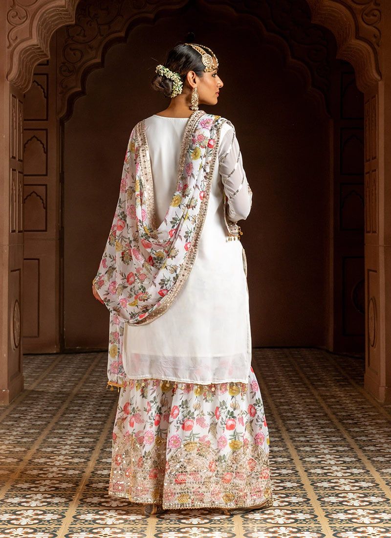 Dhiyona KL Women Floral Embroidered Regular Sequinned Kurta with Sharara & With Dupatta