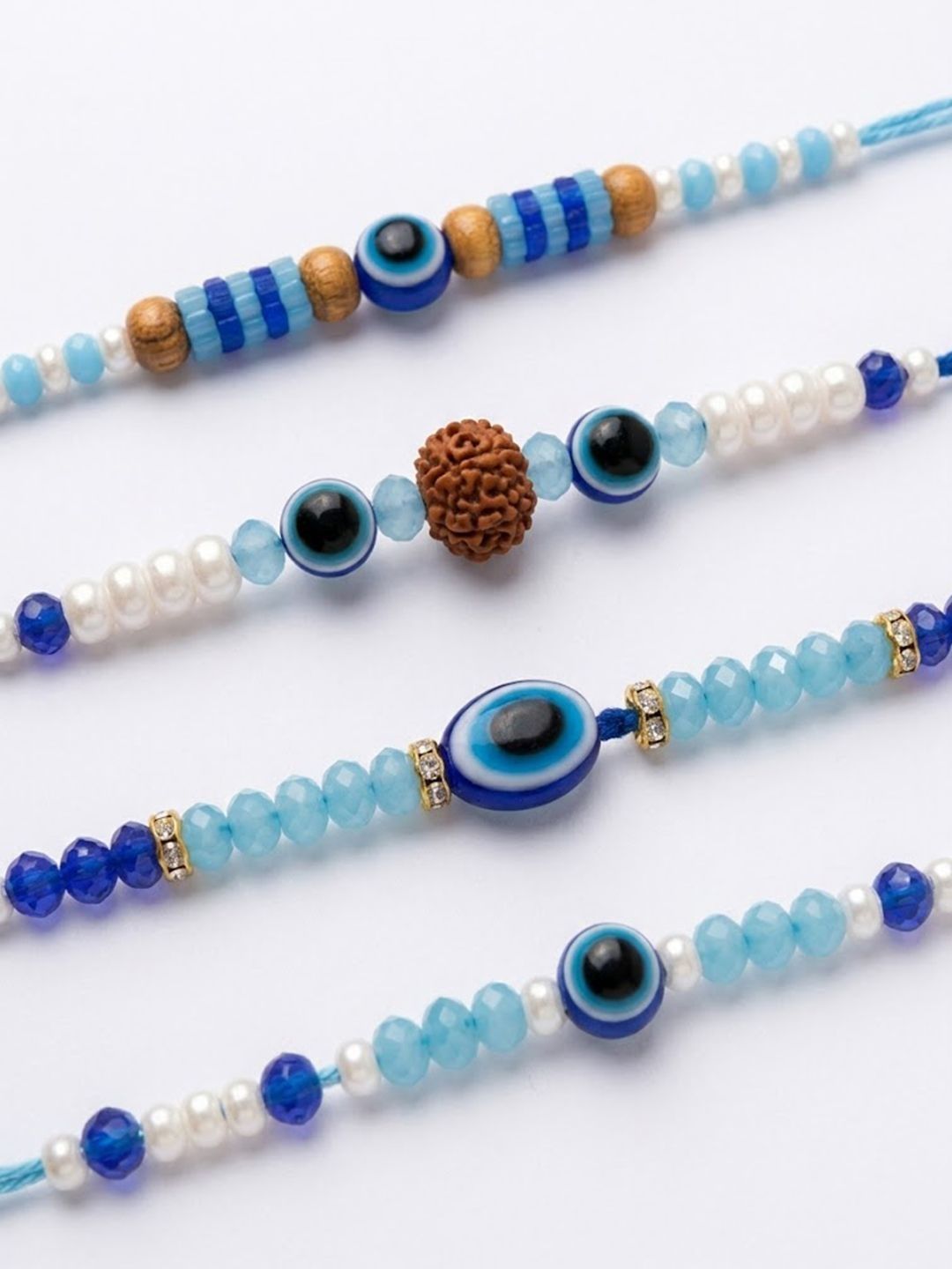 Dhiyona Set Of 4 Blue Evil Eye Thread Rakhi With Roli Chawal Chandan Mishri