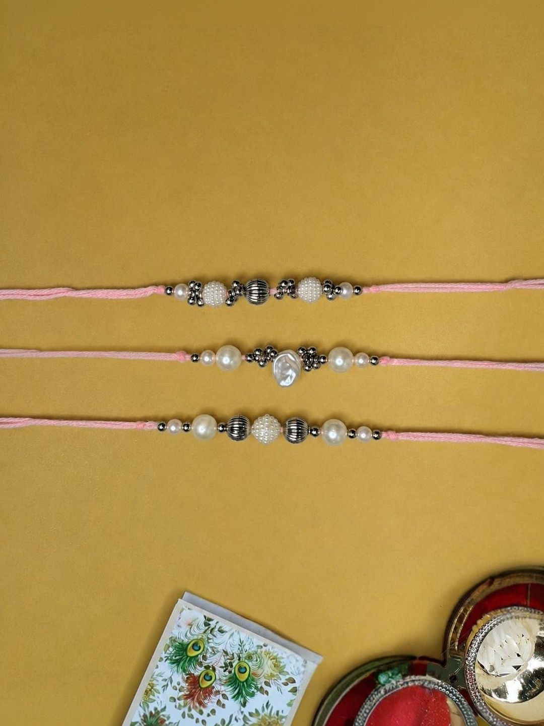 Dhiyona Set Of 3 White Pearls Thread Rakhi With Roli Chawal Chandan Mishri