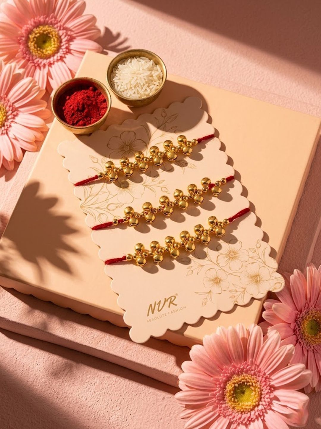 Dhiyona Set Of 3 Gold Toned Ghungroo & Red Thread Rakhi With Roli Chawal Chandan Mishri