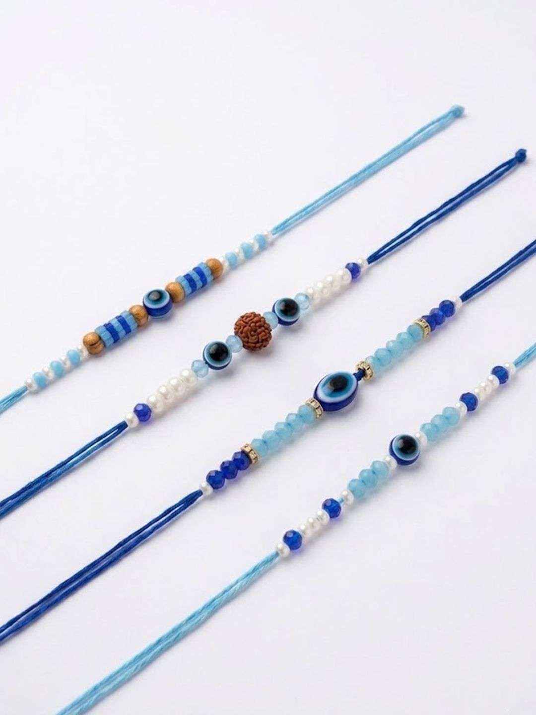 Dhiyona Set Of 4 Blue Evil Eye Thread Rakhi With Roli Chawal Chandan Mishri