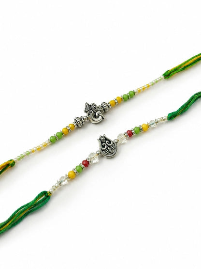 Dhiyona Set Of 2 Multicolor Religious Thread Rakhi With Roli Chawal Chandan Mishri