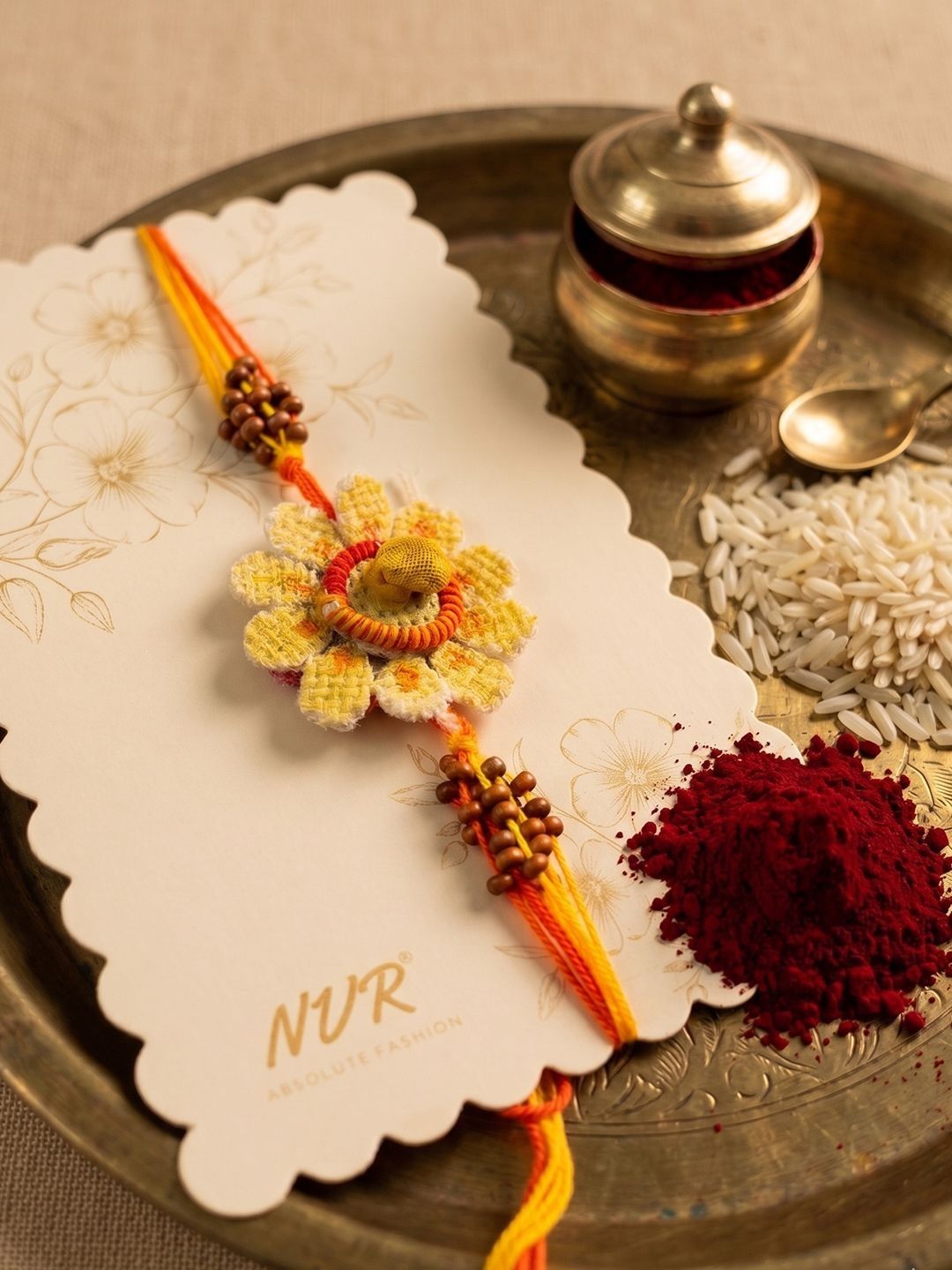 Dhiyona Yellow Floral Seed Thread Rakhi With Roli Chawal Chandan Mishri