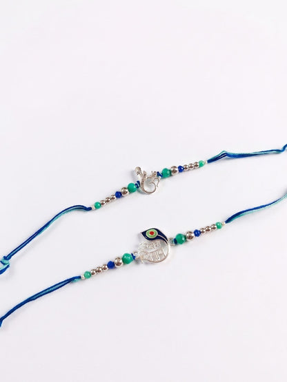 Dhiyona Set Of 2 Silver Toned Beaded Religious Thread Rakhi With Roli Chawal Chandan Mishri